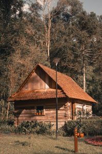 Charming wooden cabin set amidst trees in Curitiba, Brazil, capturing rustic and natural beauty.